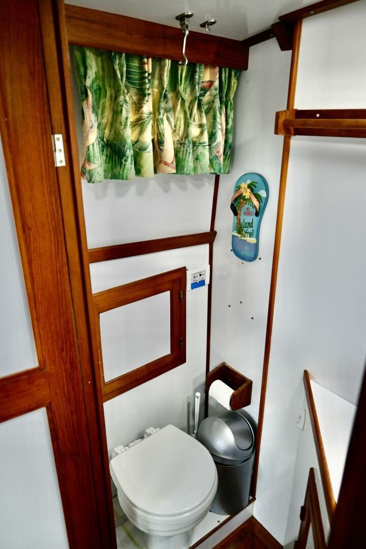 a toilet with a planter on the wall aboard LITTLE BAYOU Yacht for Sale