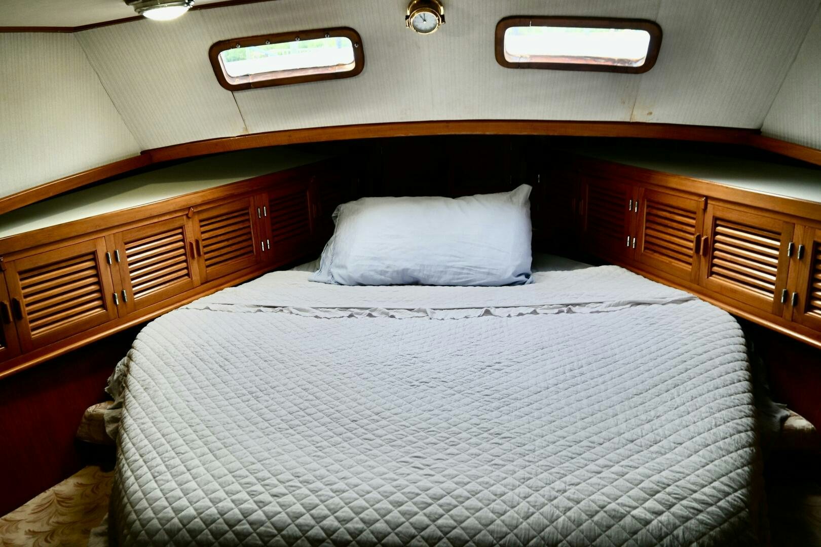 a bed with a white pillow aboard LITTLE BAYOU Yacht for Sale