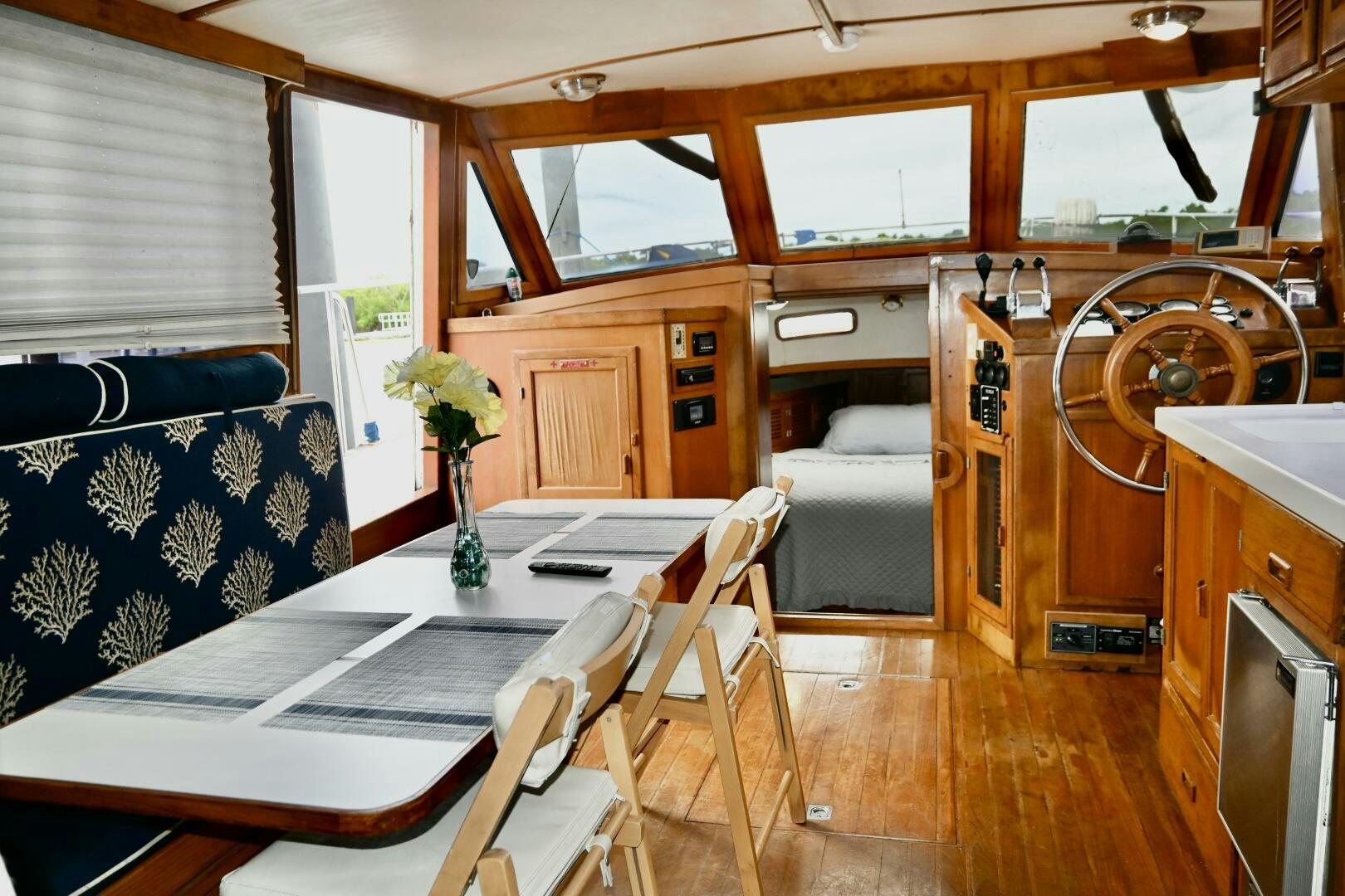 a living room with a table and chairs aboard LITTLE BAYOU Yacht for Sale