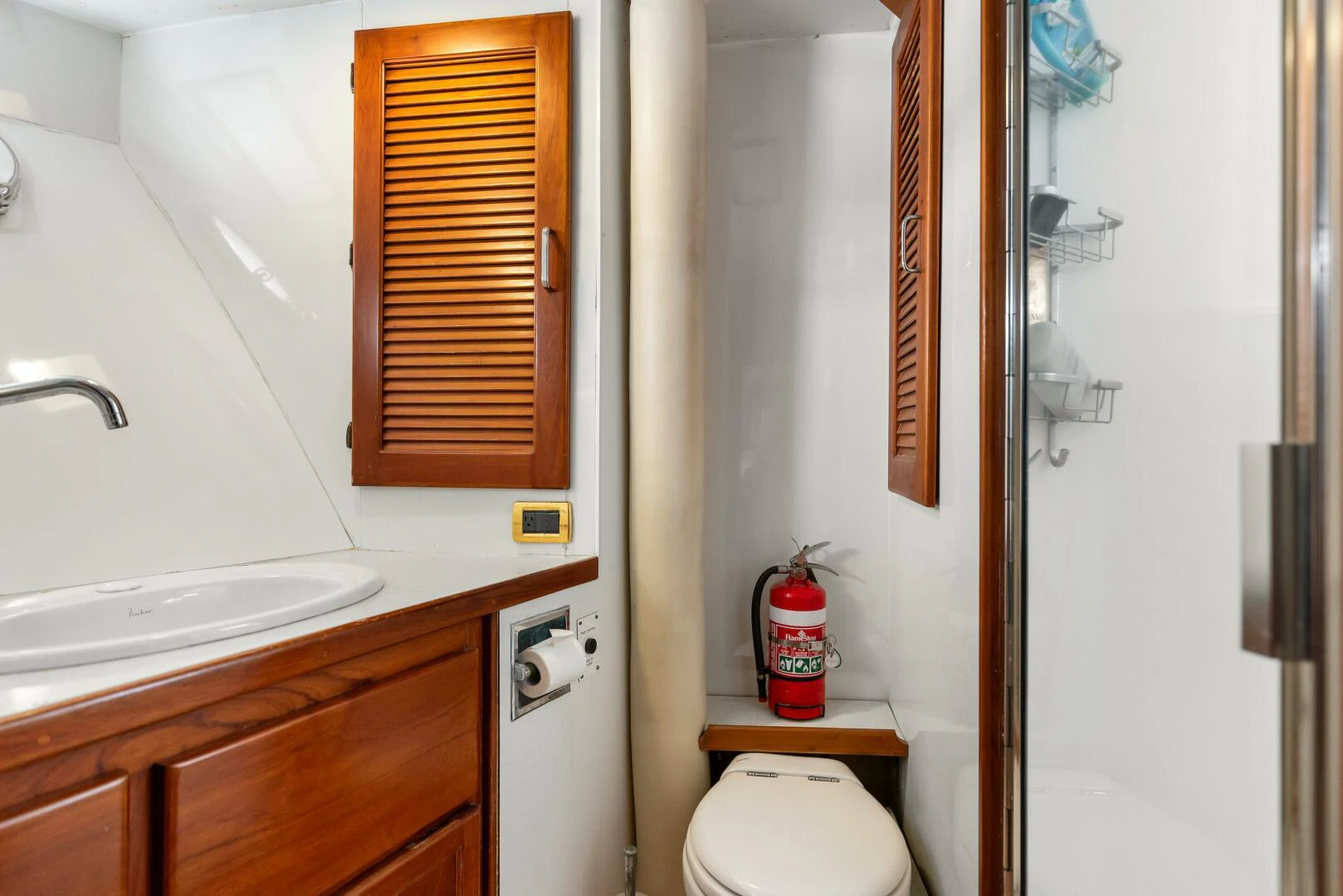 a bathroom with a toilet and sink aboard HUNTRESS Yacht for Sale