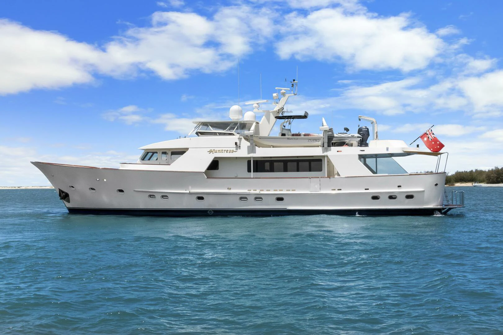 a white yacht in the water aboard HUNTRESS Yacht for Sale