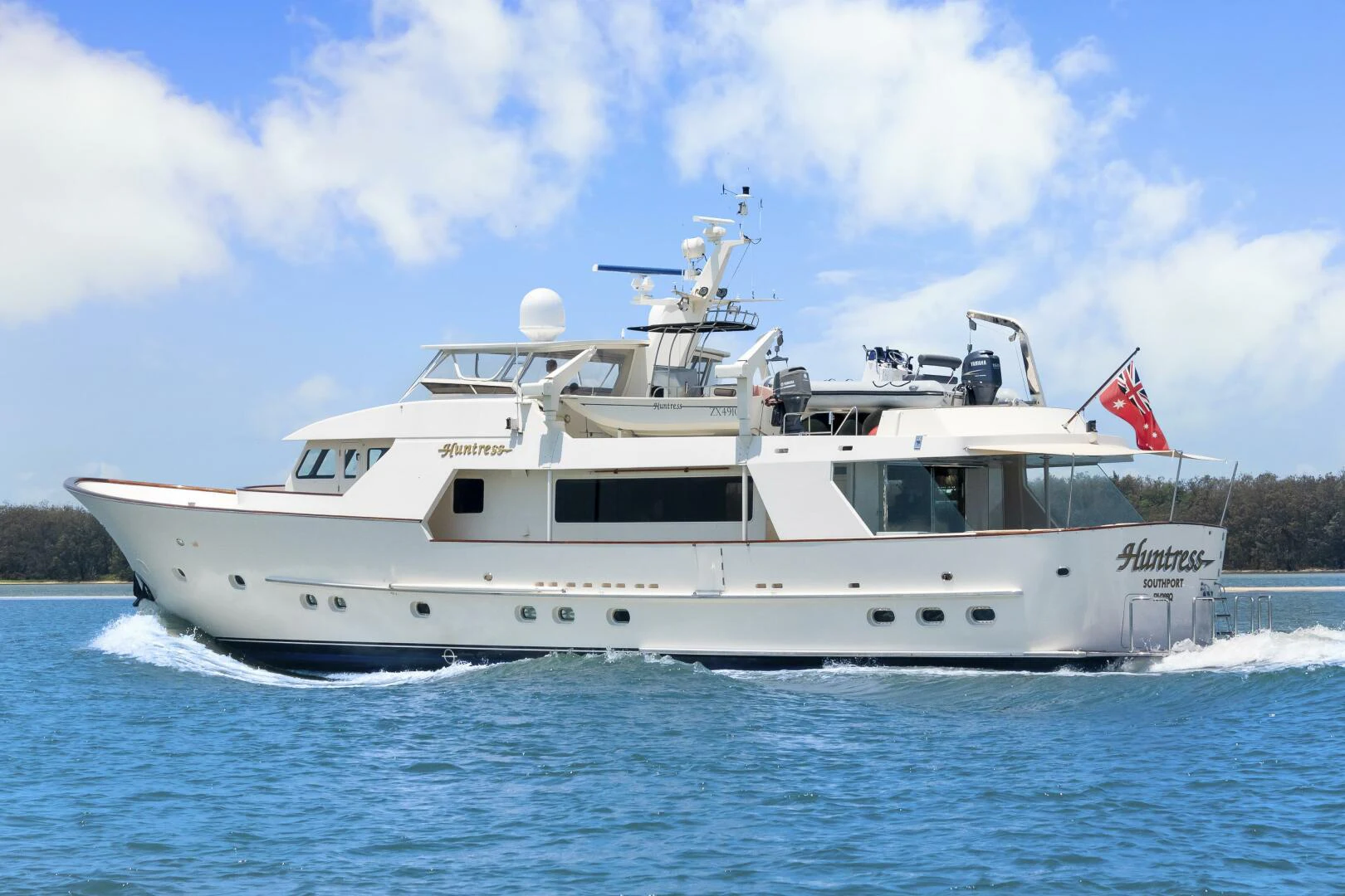 a large white boat on the water aboard HUNTRESS Yacht for Sale