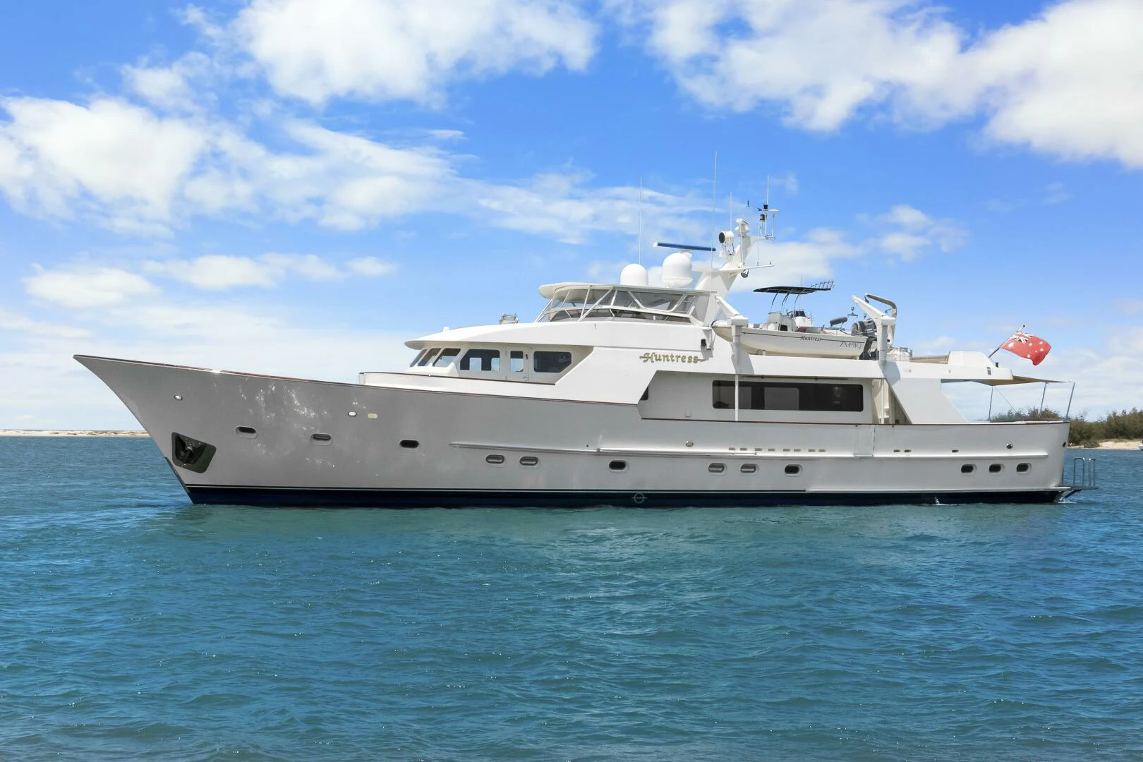 a white yacht in the water aboard HUNTRESS Yacht for Sale