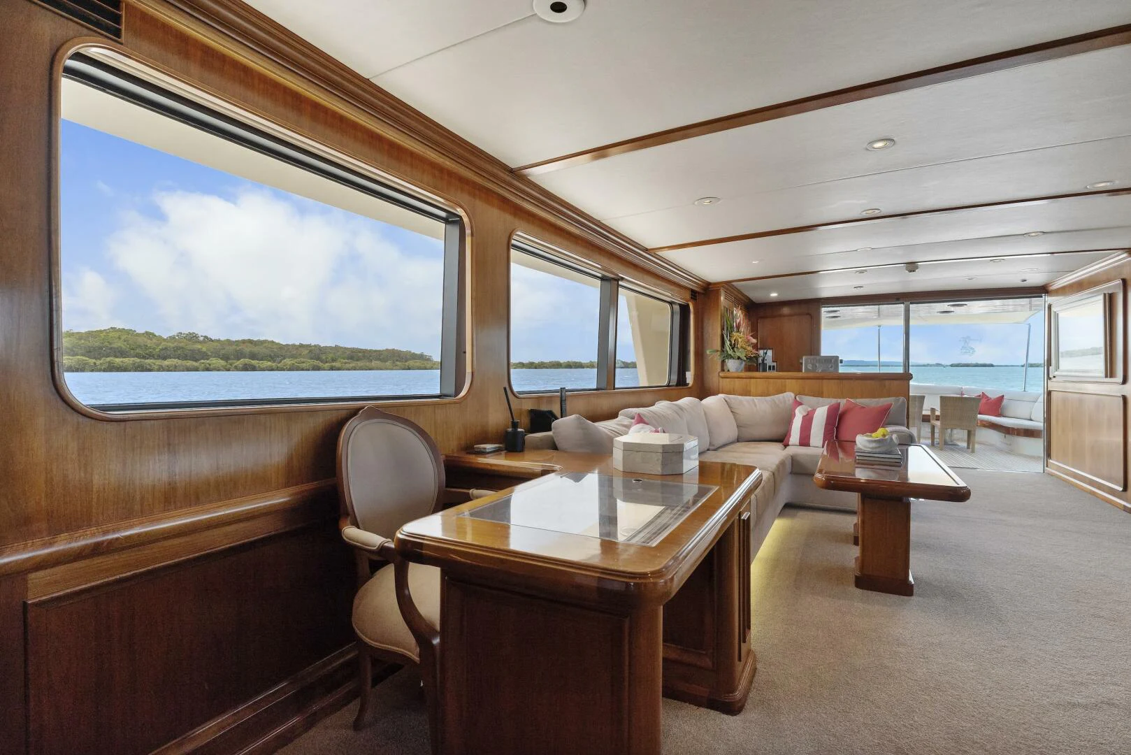 a room with a couch and a table and a window aboard HUNTRESS Yacht for Sale