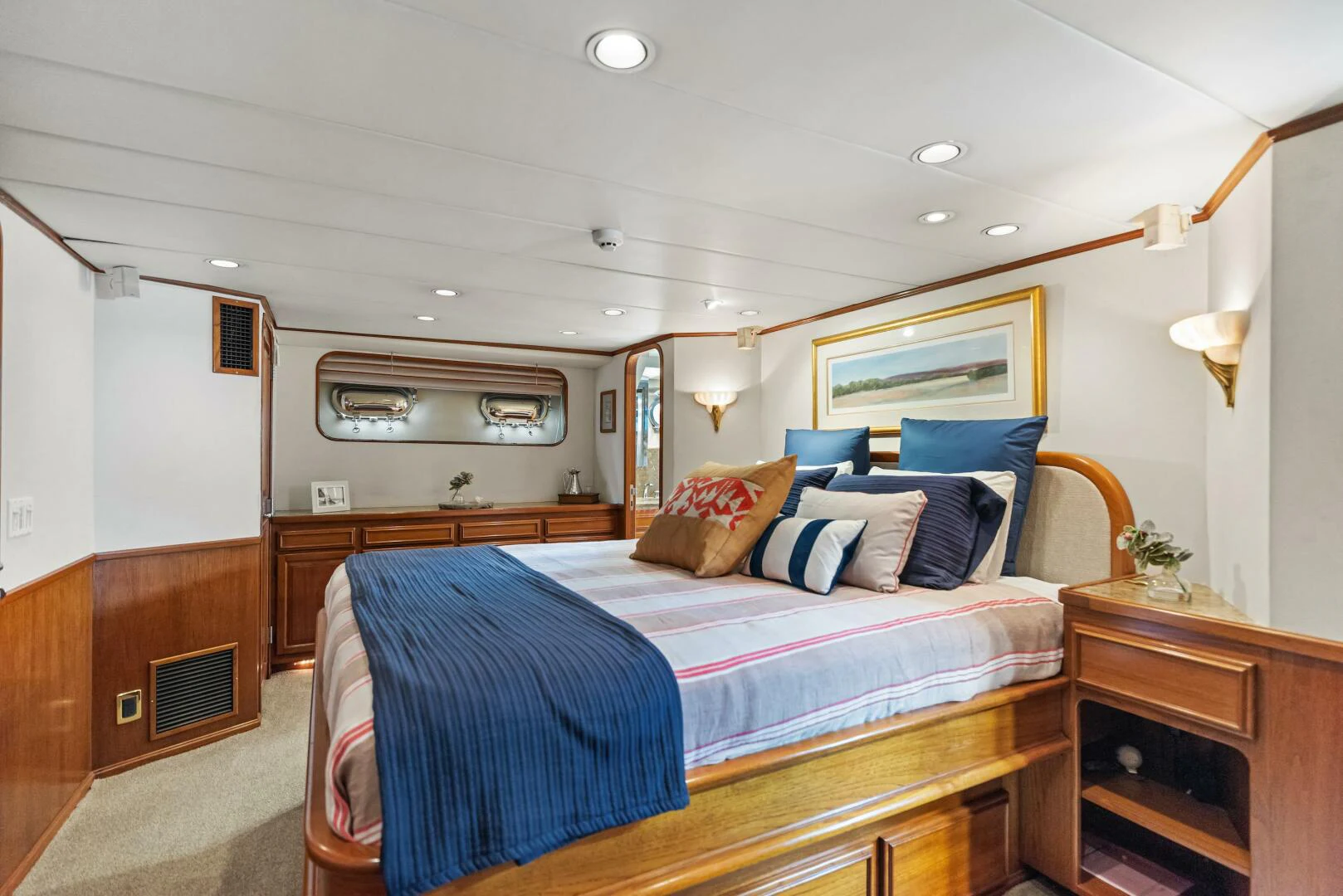 a bedroom with a bed and a dresser aboard HUNTRESS Yacht for Sale
