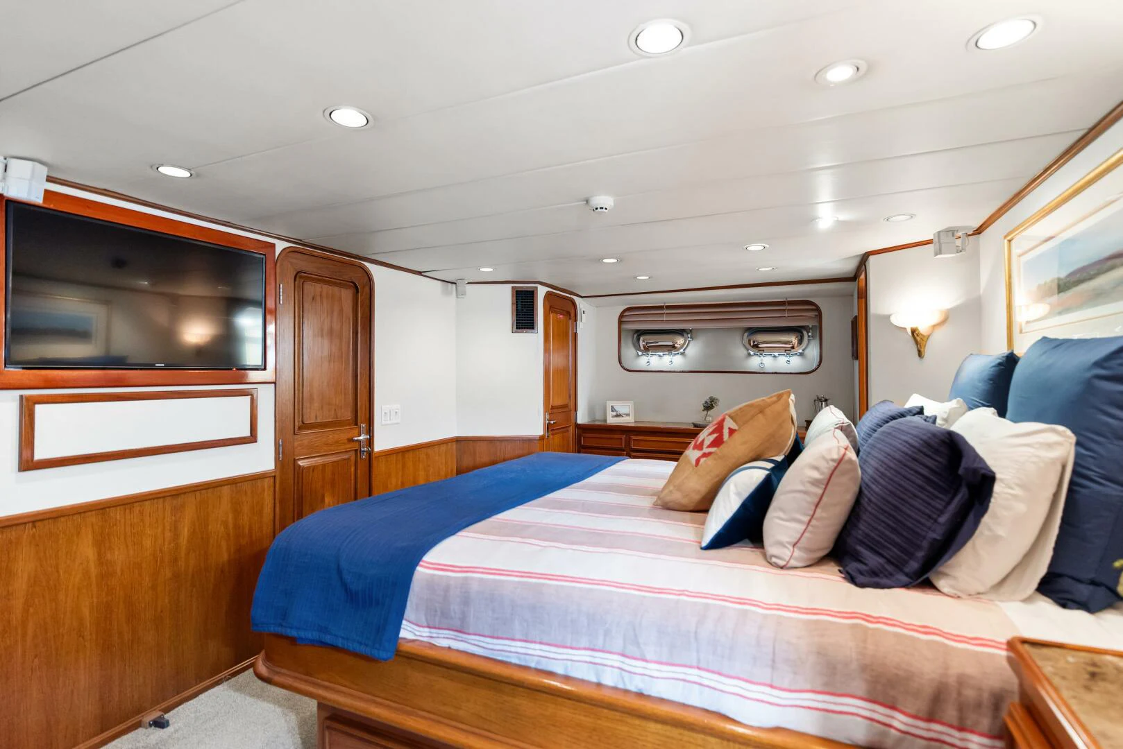 a bedroom with a bed and a television aboard HUNTRESS Yacht for Sale