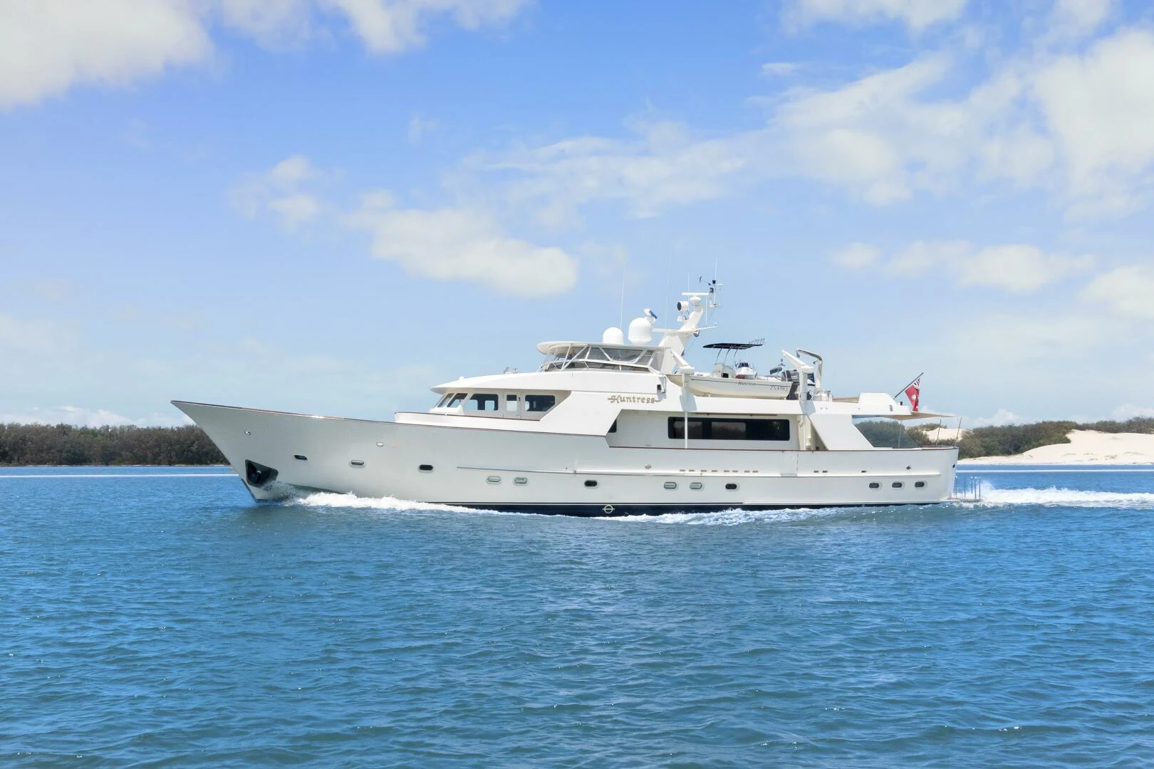 a white yacht in the water aboard HUNTRESS Yacht for Sale