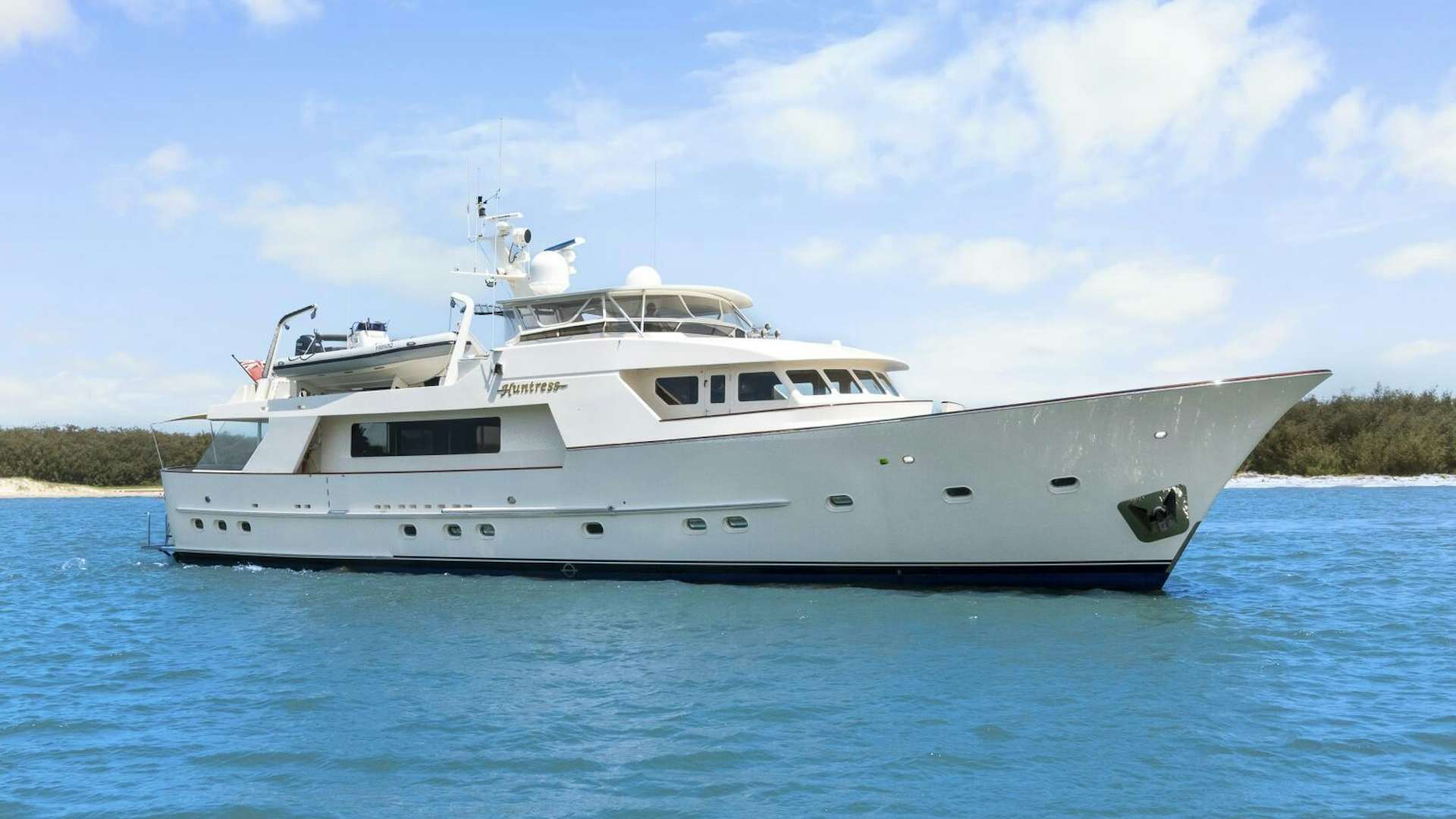 a white boat in the water aboard HUNTRESS Yacht for Sale