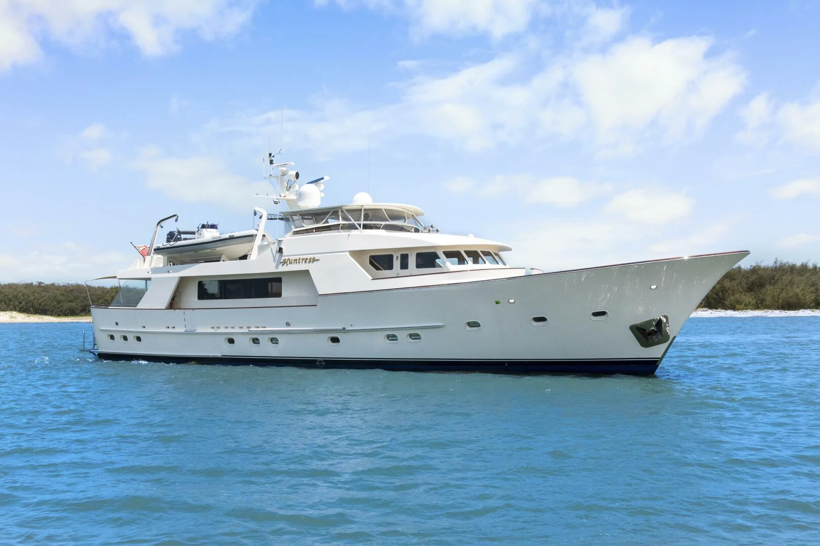 a white yacht in the water aboard HUNTRESS Yacht for Sale