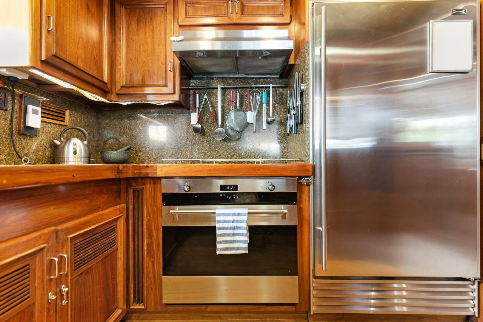 a kitchen with wooden cabinets aboard HUNTRESS Yacht for Sale
