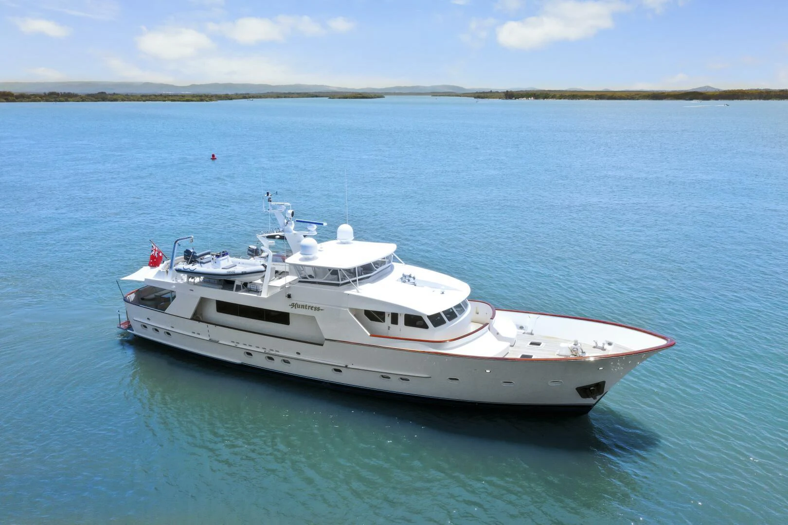 a white boat in the water aboard HUNTRESS Yacht for Sale