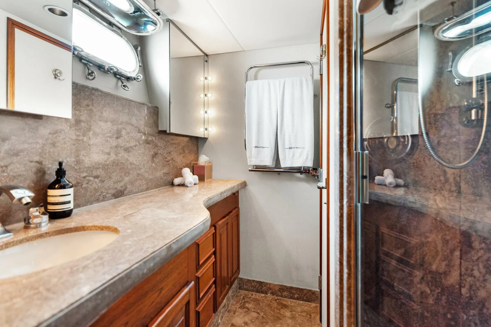 a bathroom with a sink and a mirror aboard HUNTRESS Yacht for Sale