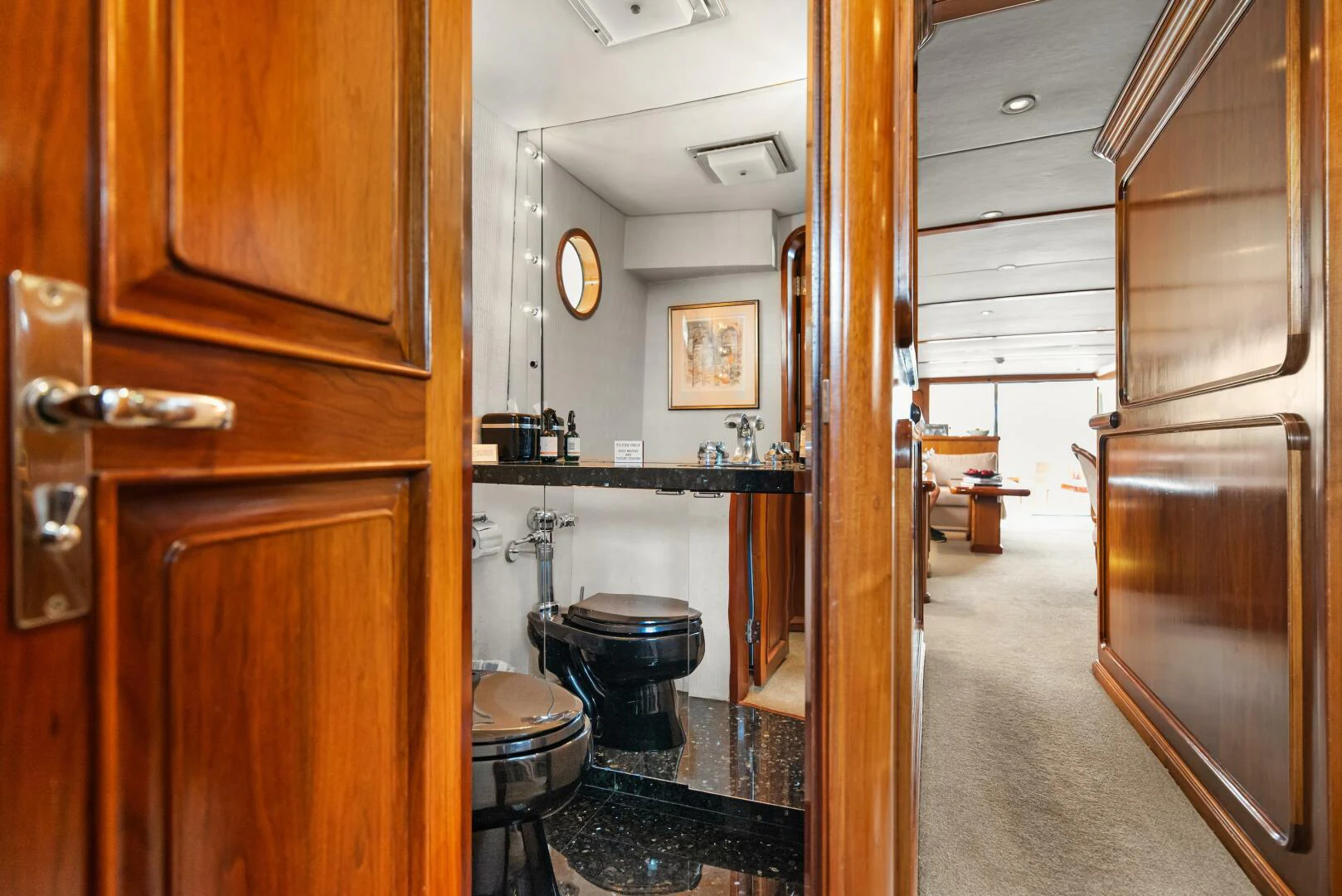 a bathroom with wood cabinets aboard HUNTRESS Yacht for Sale