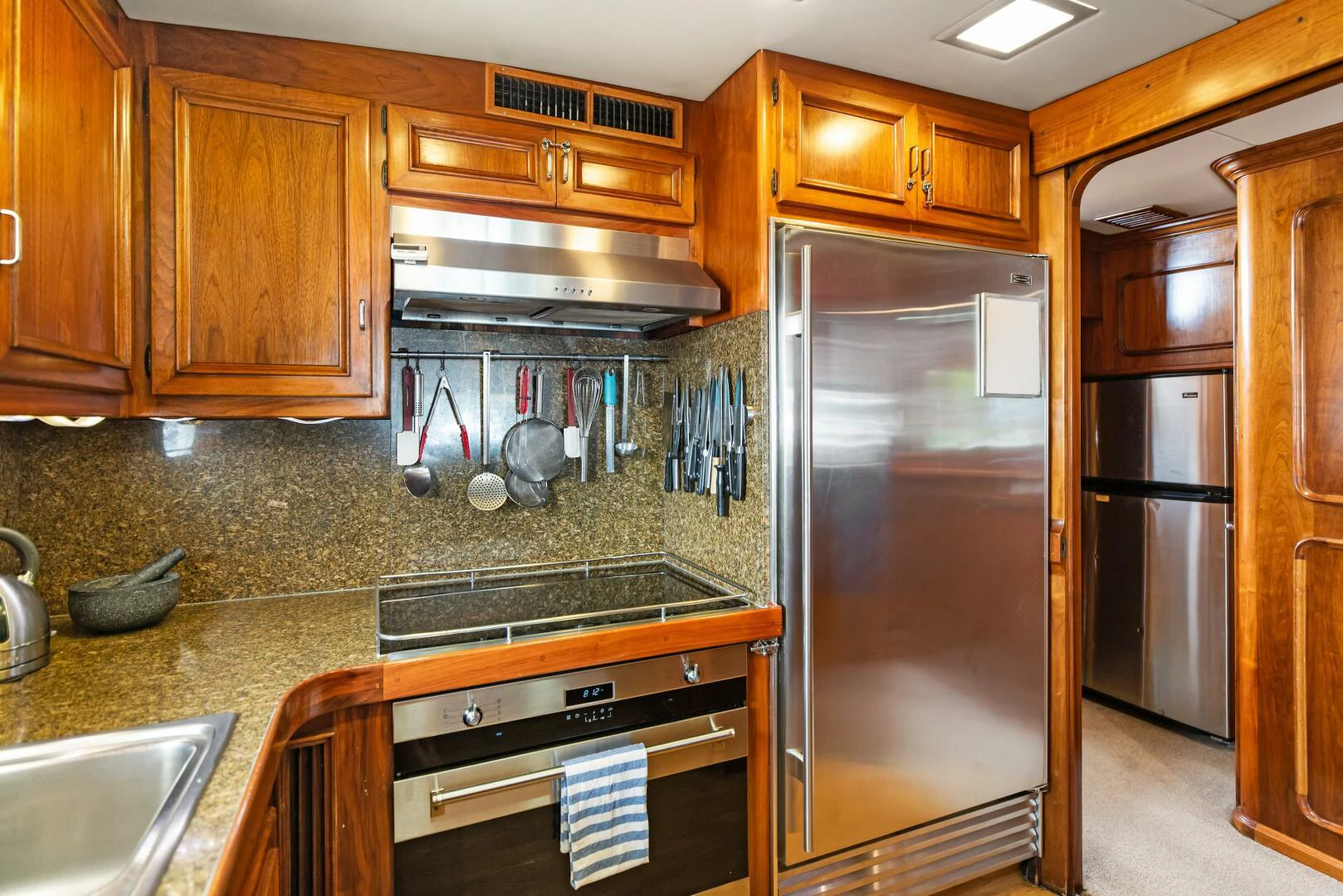 a kitchen with stainless steel appliances aboard HUNTRESS Yacht for Sale