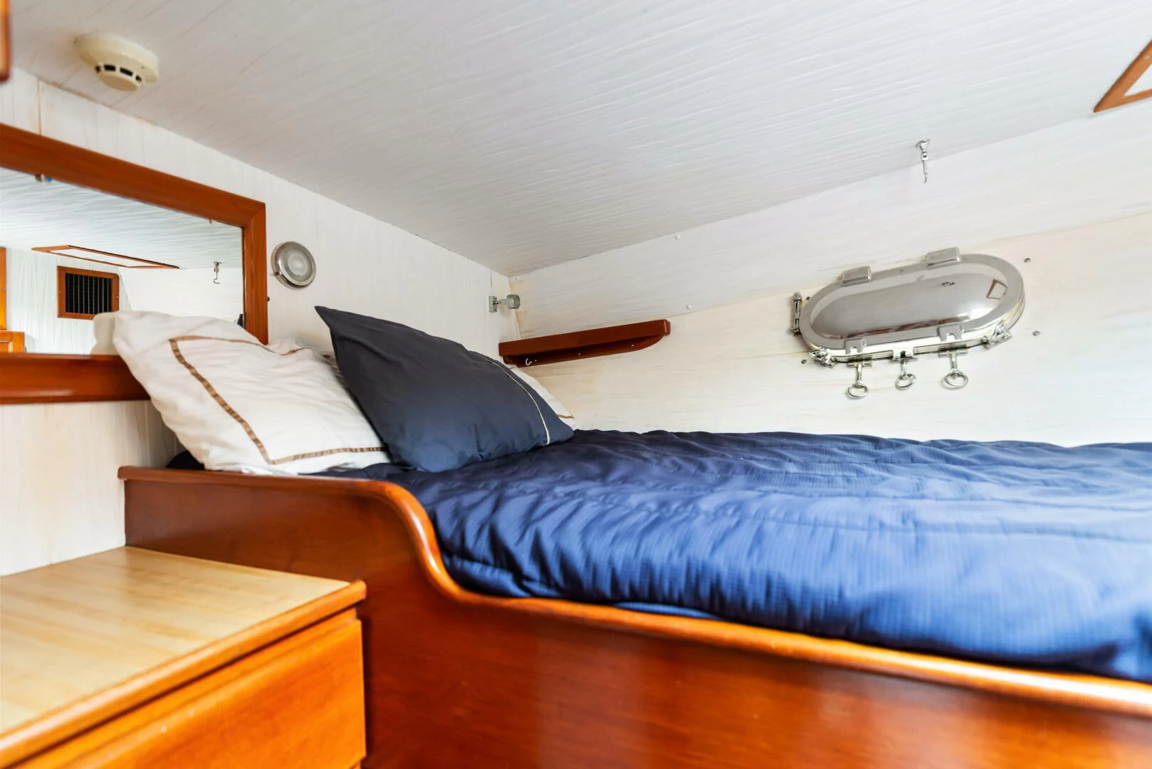 a bed with a blue comforter aboard HUNTRESS Yacht for Sale