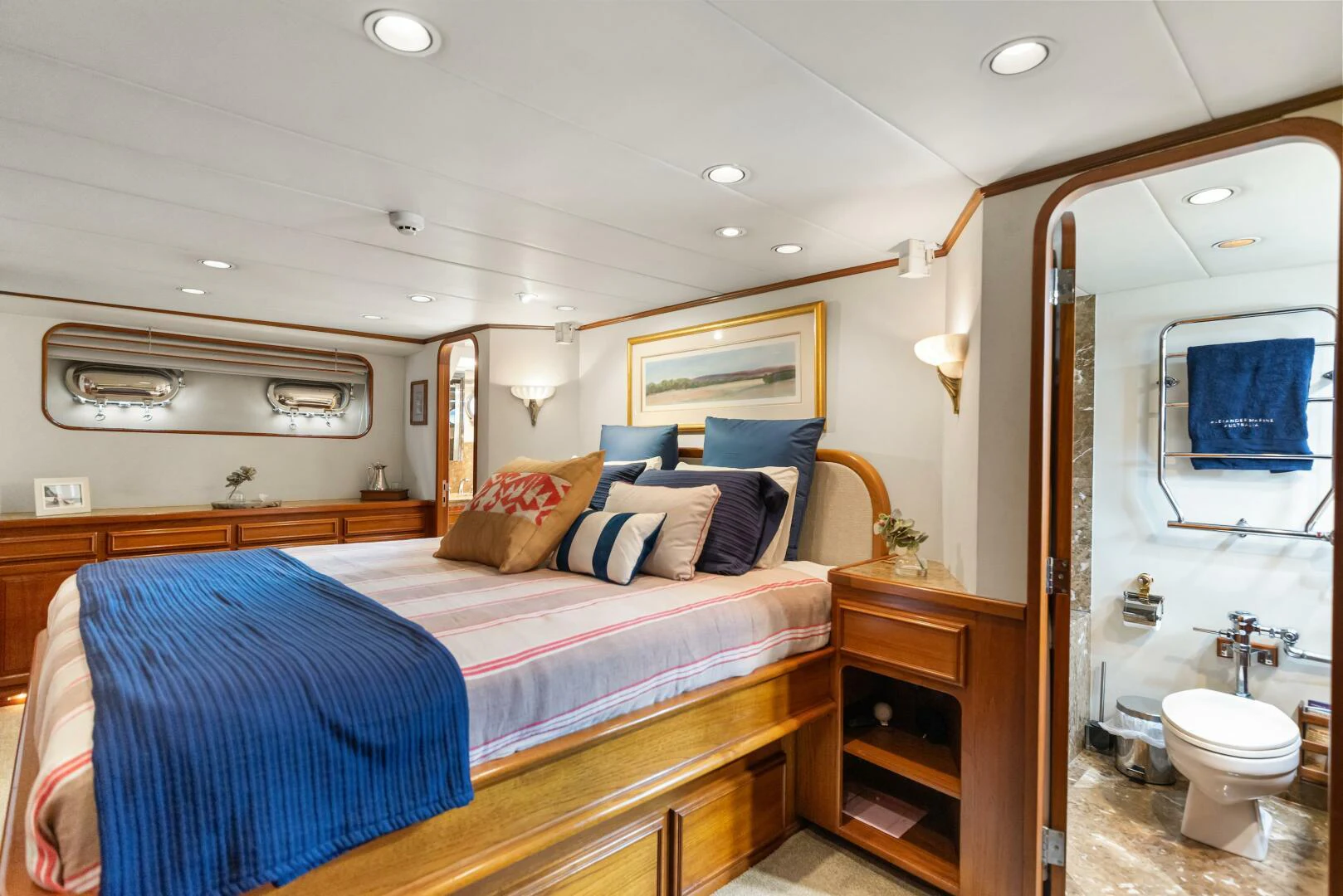 a bedroom with a bed and a mirror aboard HUNTRESS Yacht for Sale