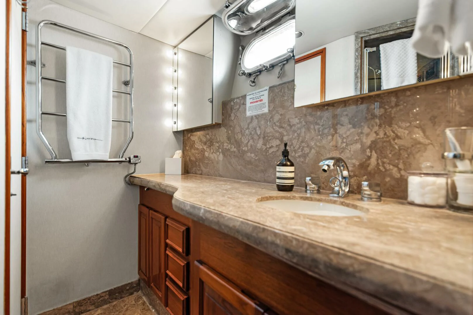 a bathroom with a sink and a mirror aboard HUNTRESS Yacht for Sale