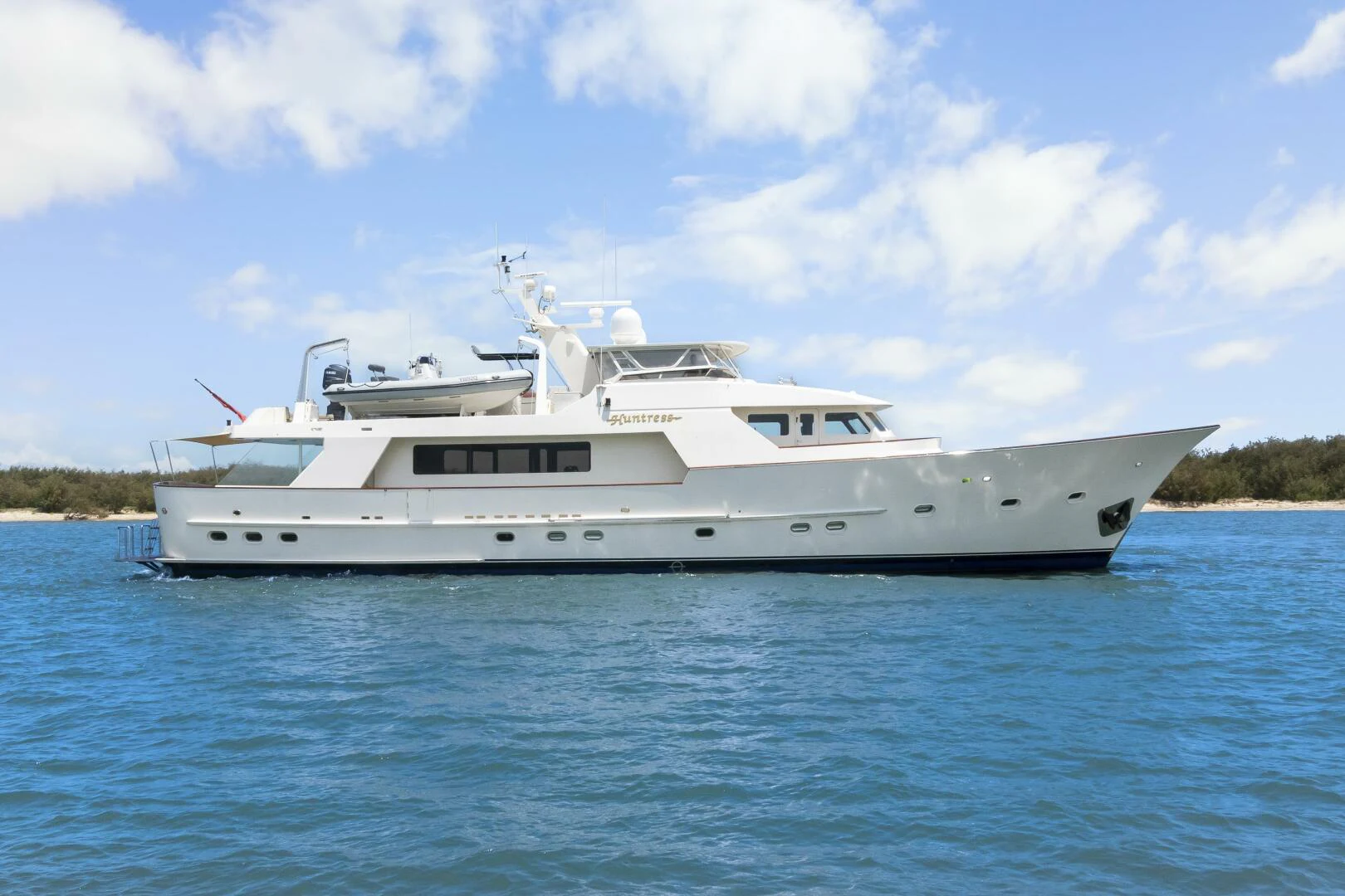 a white yacht in the water aboard HUNTRESS Yacht for Sale
