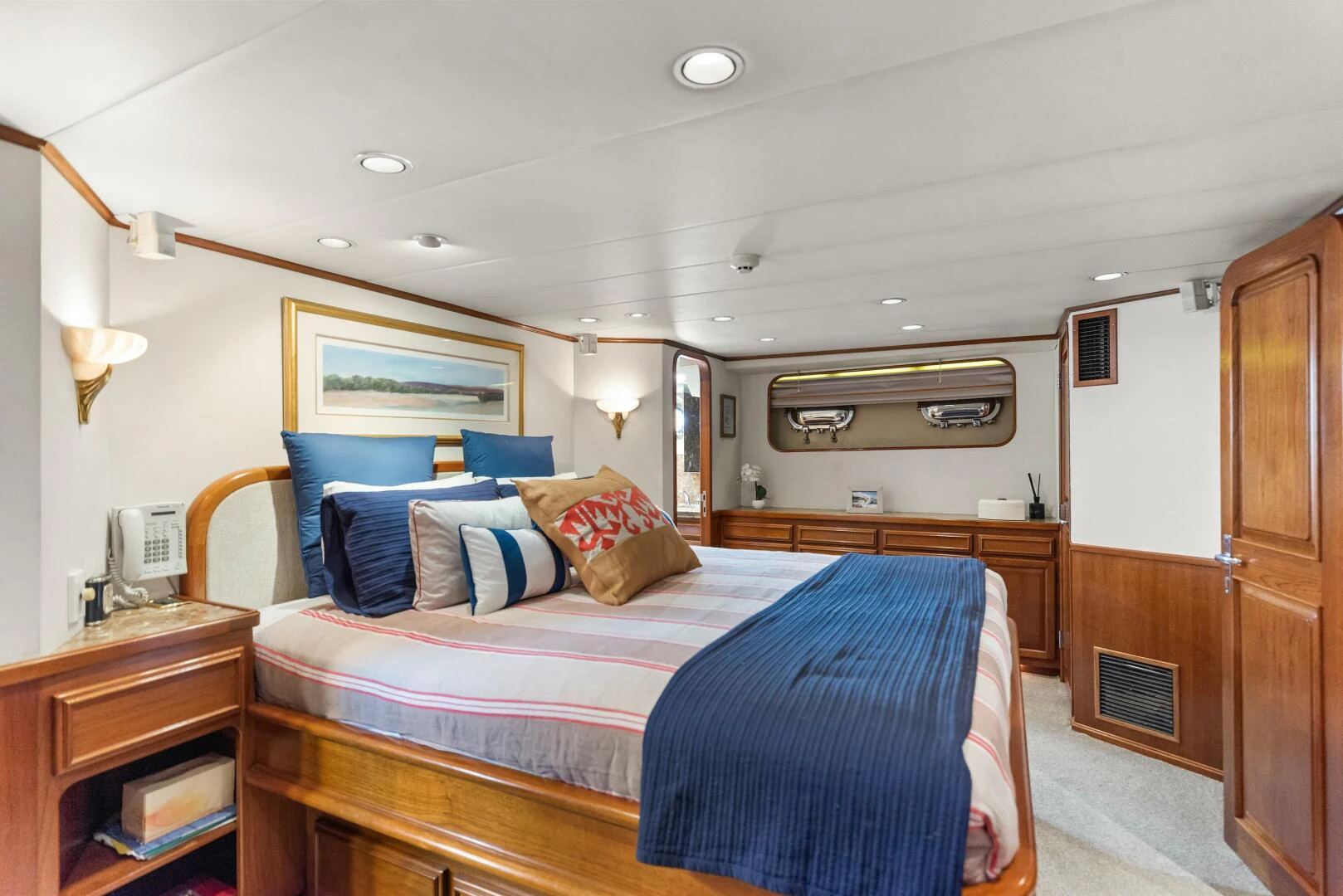 a bedroom with a bed and a desk aboard HUNTRESS Yacht for Sale
