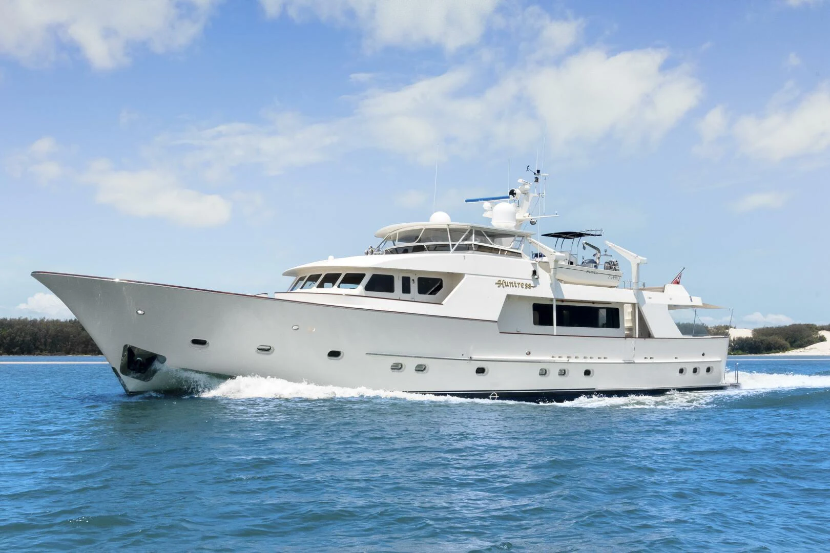 a white yacht on the water aboard HUNTRESS Yacht for Sale