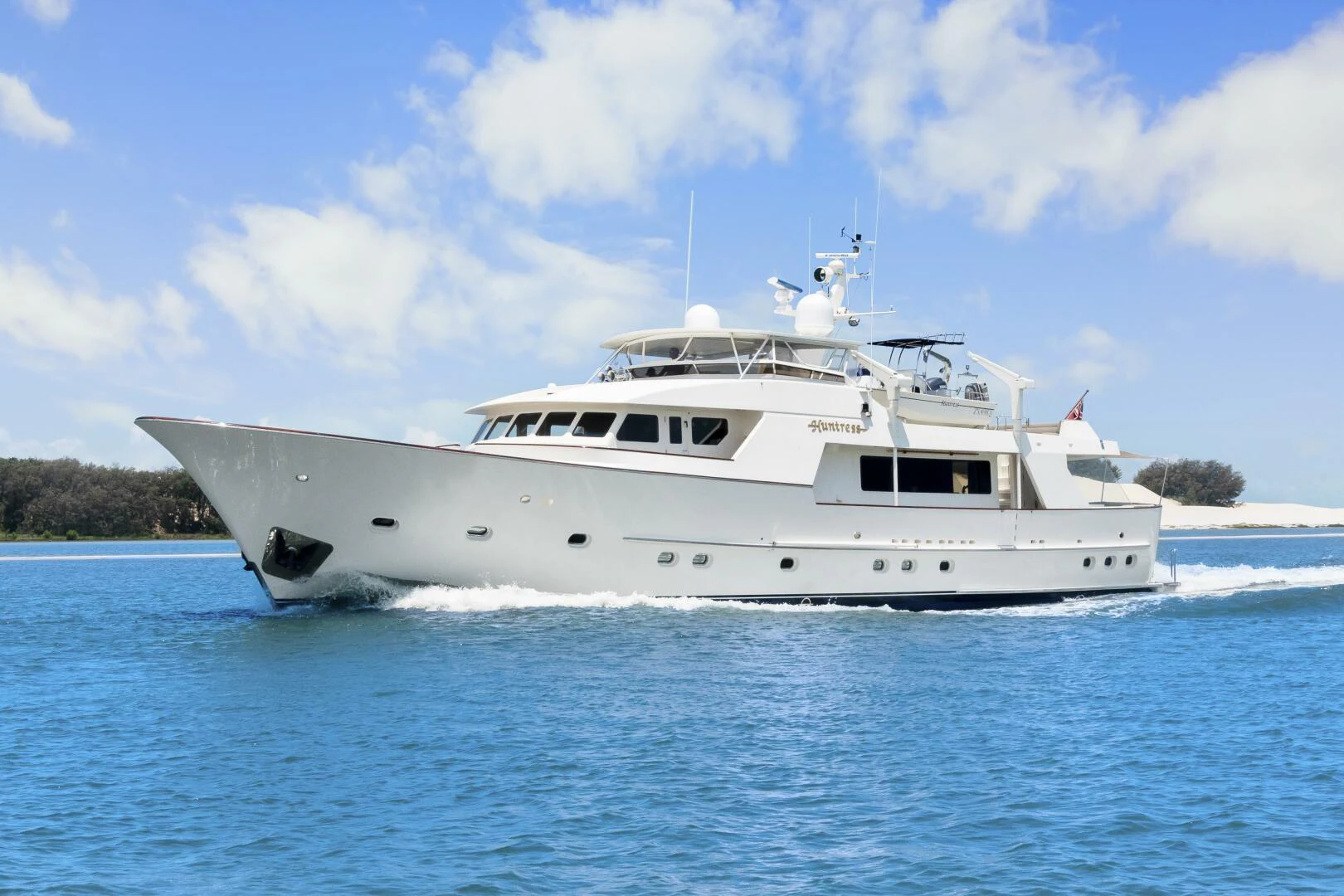 a white yacht on the water aboard HUNTRESS Yacht for Sale
