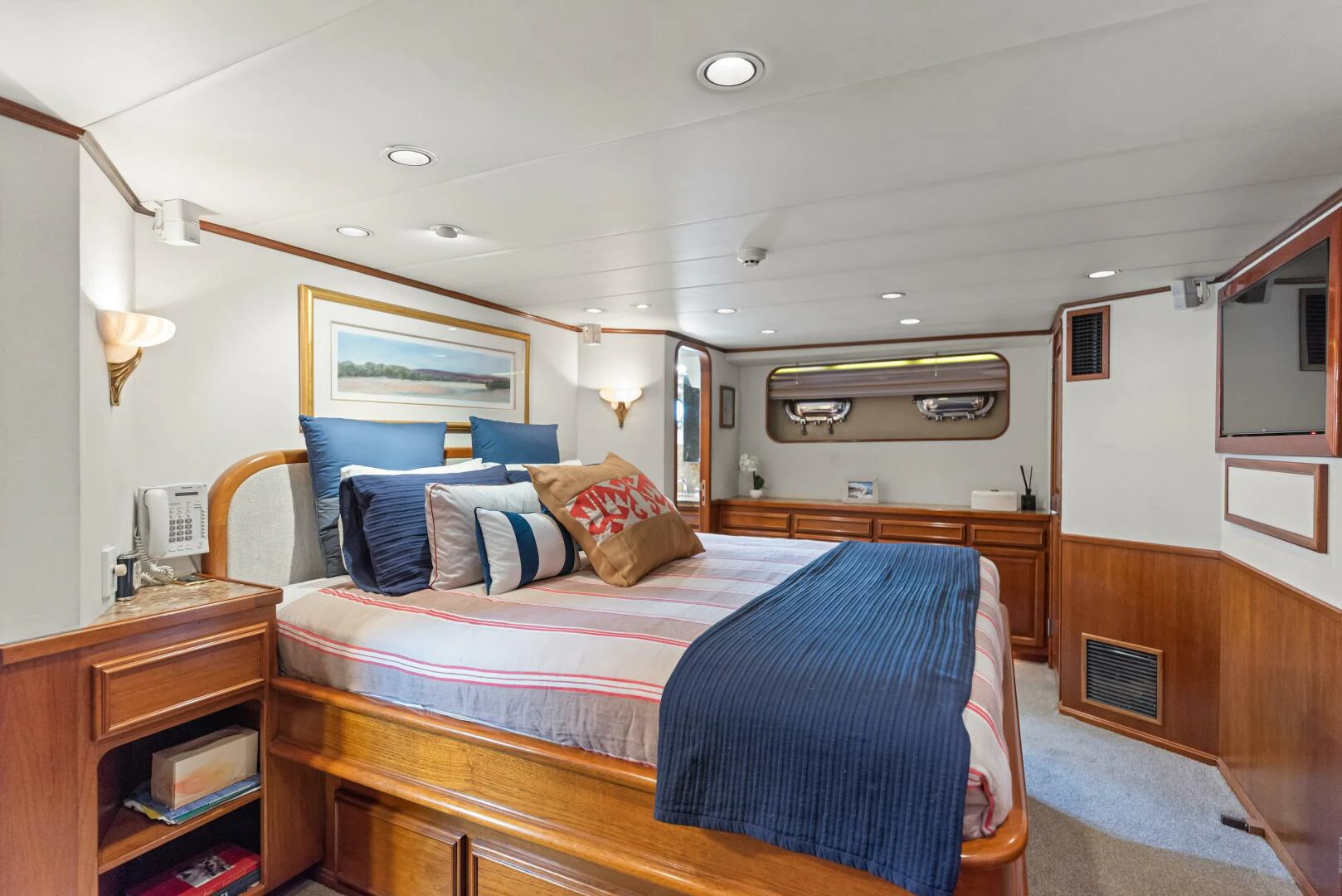 a bedroom with a bed and a desk aboard HUNTRESS Yacht for Sale