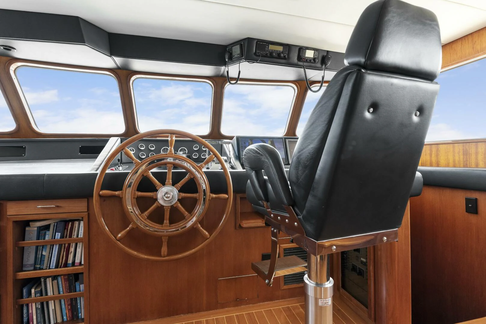 a steering wheel and a chair in a car aboard HUNTRESS Yacht for Sale