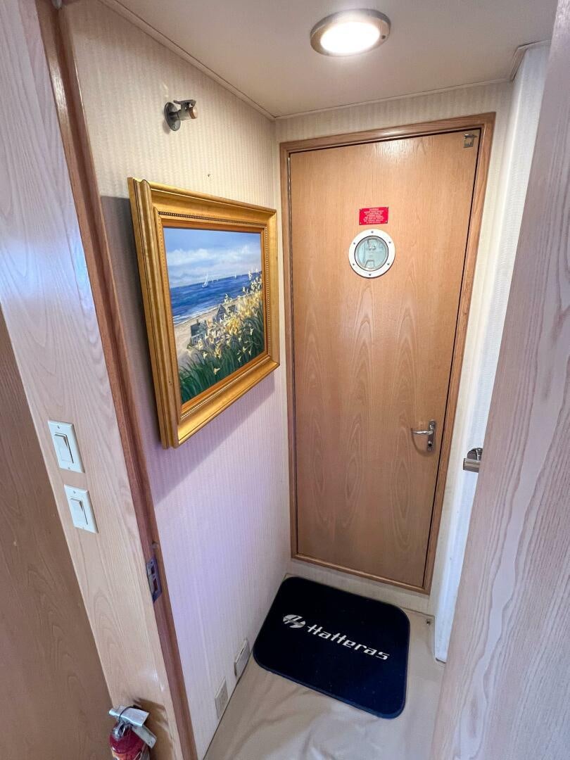 a door with a painting on the wall aboard AT EASE Yacht for Sale