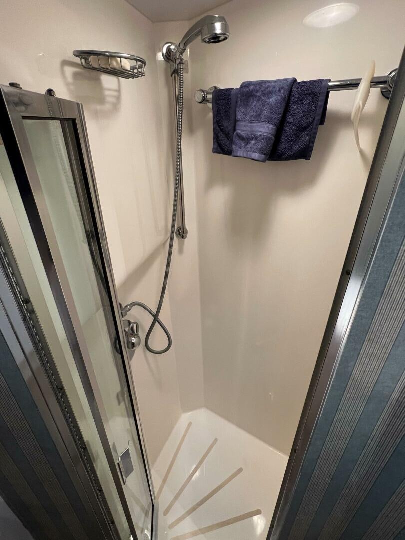 a shower with towels on the wall aboard AT EASE Yacht for Sale