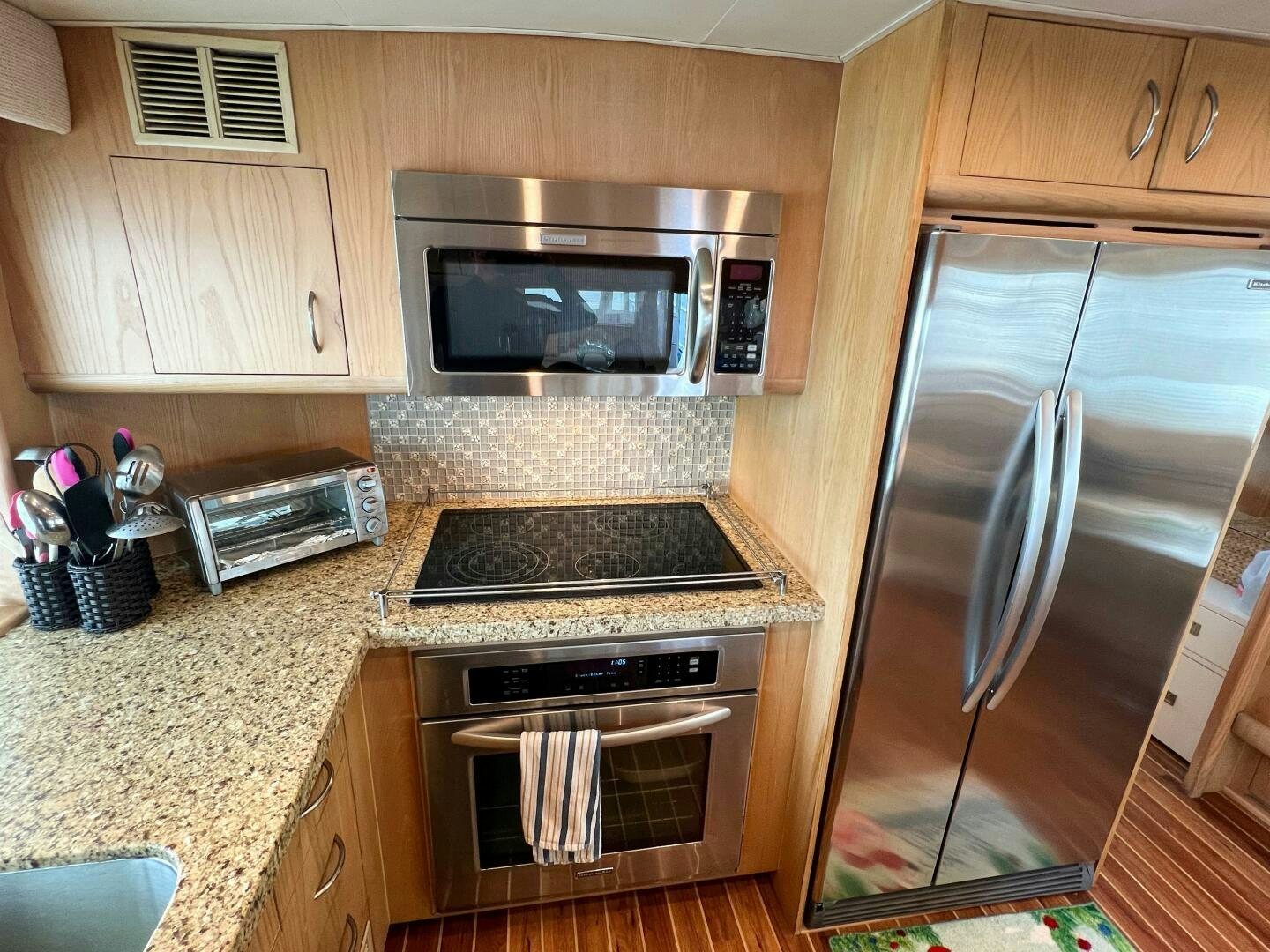 a kitchen with a stainless steel oven aboard AT EASE Yacht for Sale