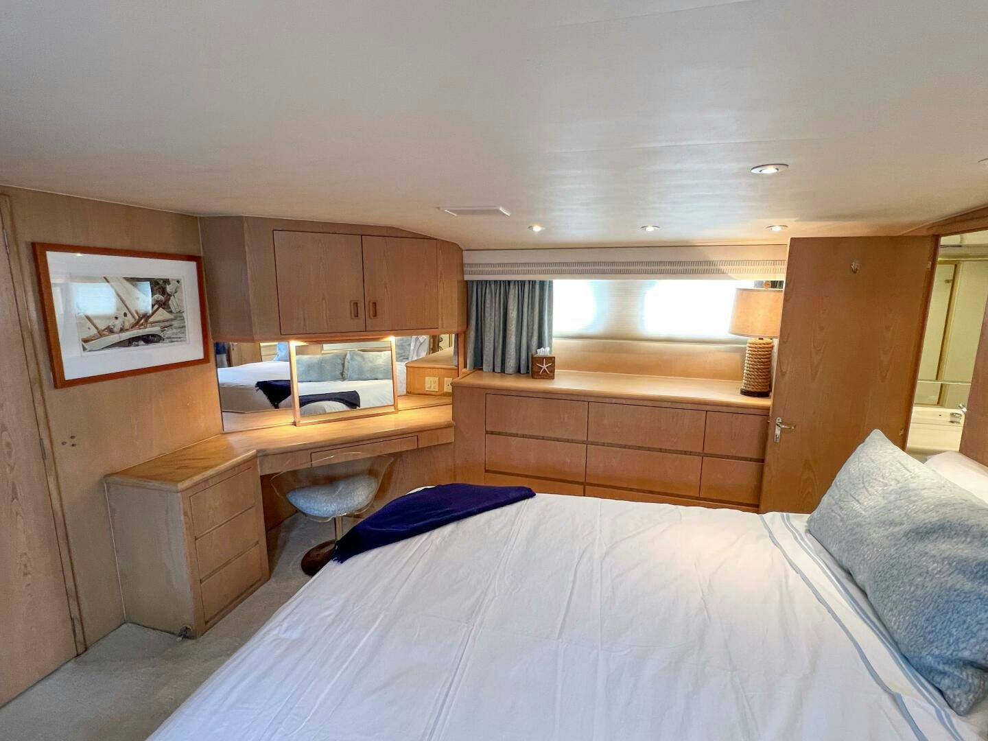 a bedroom with a bed and desk aboard AT EASE Yacht for Sale
