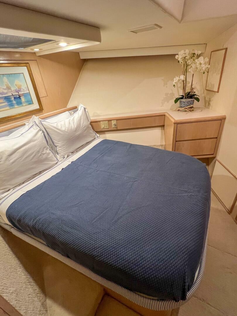 a bed with white sheets aboard AT EASE Yacht for Sale