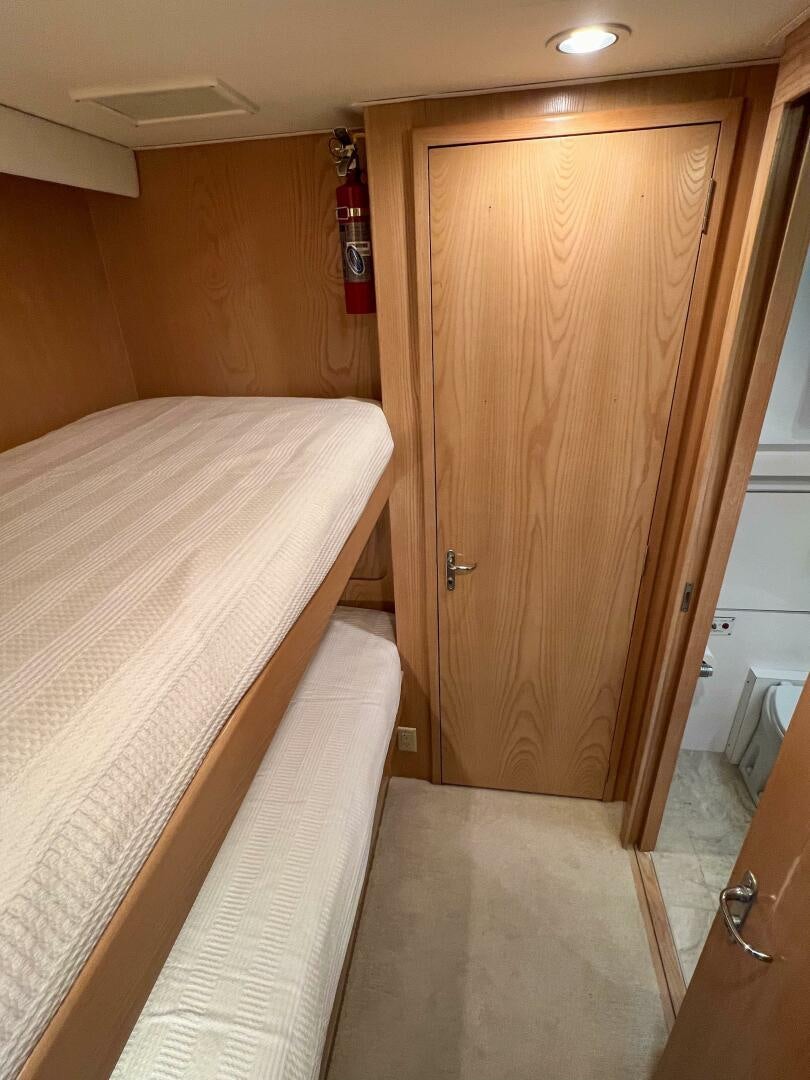 a bedroom with a wood door aboard AT EASE Yacht for Sale