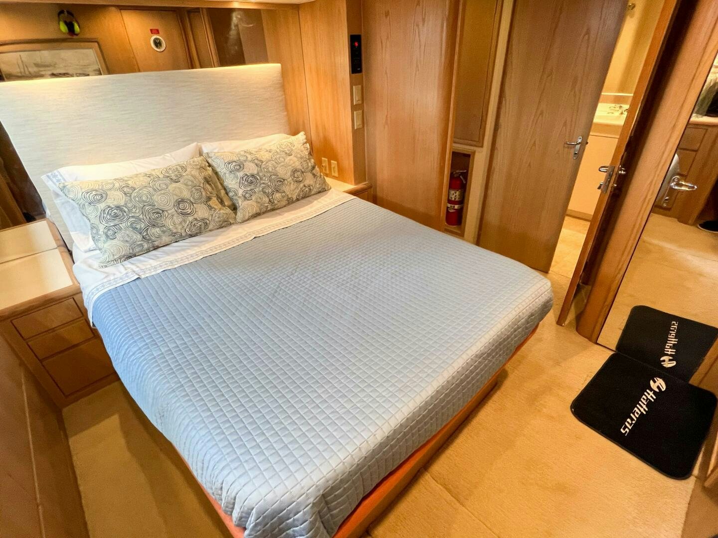 a bed with a blue cover aboard AT EASE Yacht for Sale