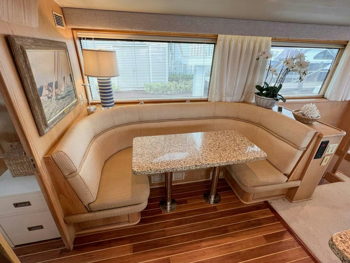 a living room with a table and chairs aboard AT EASE Yacht for Sale