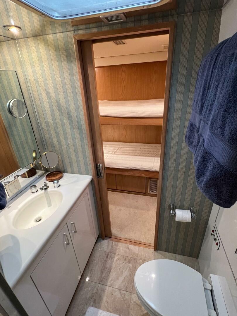 a bathroom with a toilet and a sink aboard AT EASE Yacht for Sale