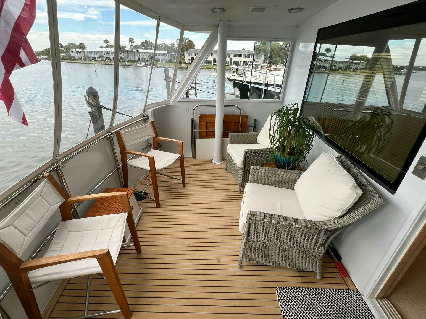 a boat with a bench and chairs aboard AT EASE Yacht for Sale