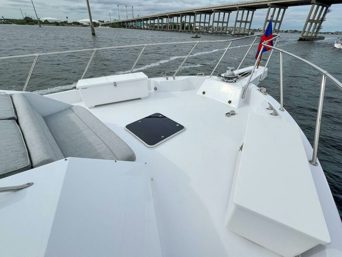a boat with a flag on the front aboard AT EASE Yacht for Sale