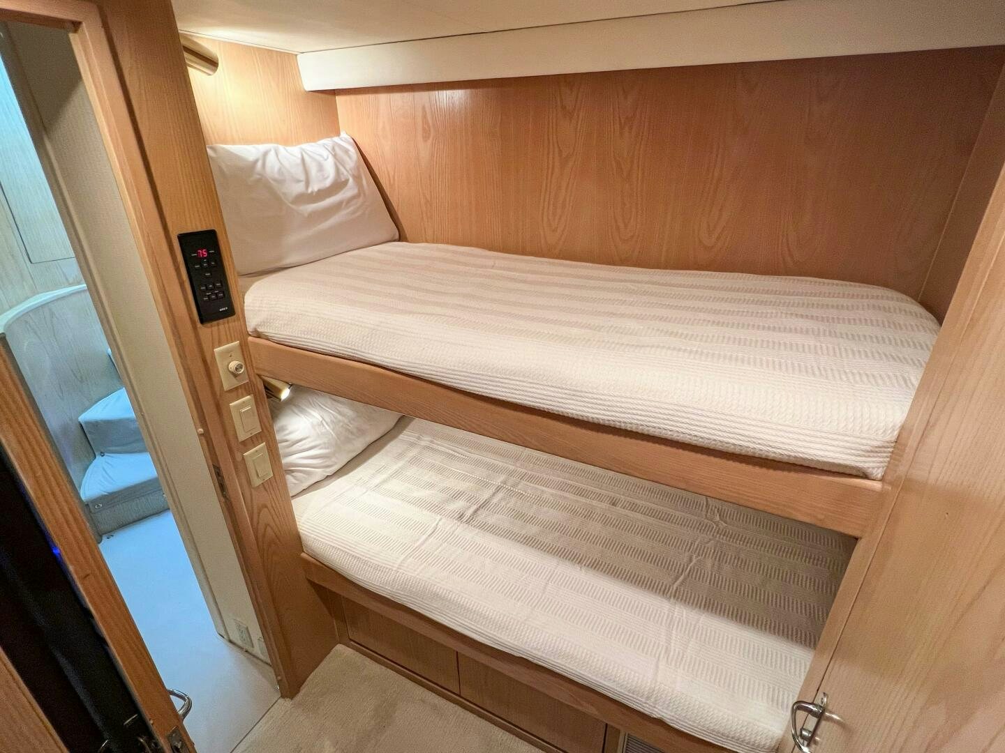 a bed with a wooden headboard aboard AT EASE Yacht for Sale