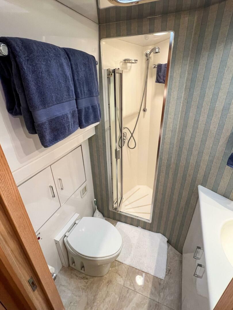 a bathroom with a shower curtain aboard AT EASE Yacht for Sale