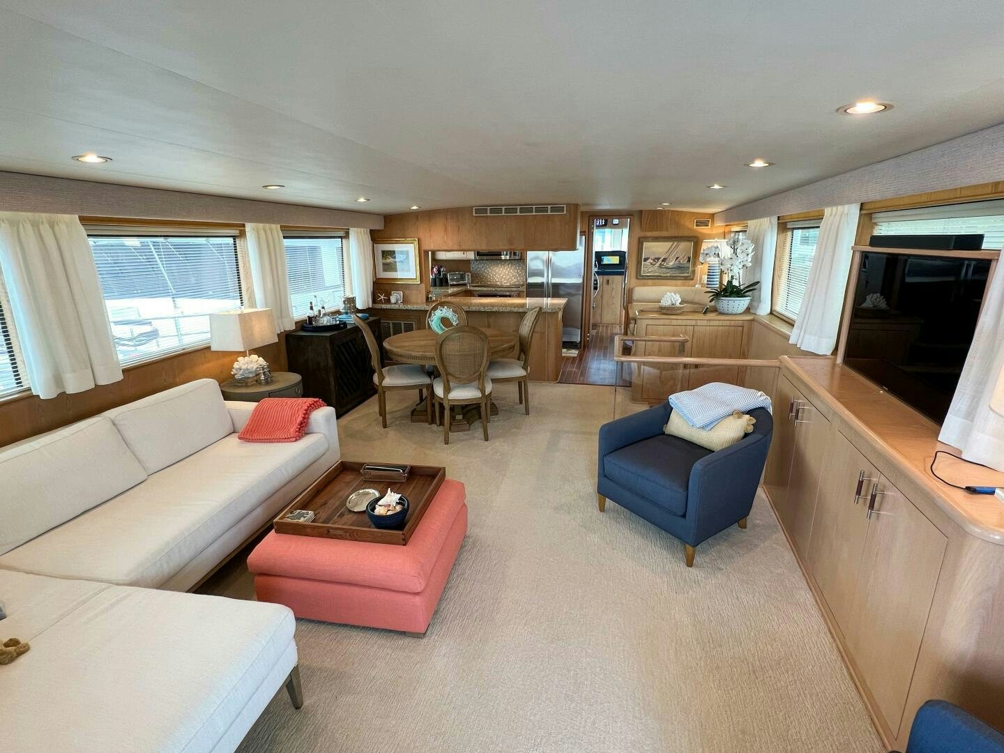 a living room with a kitchen and dining area aboard AT EASE Yacht for Sale
