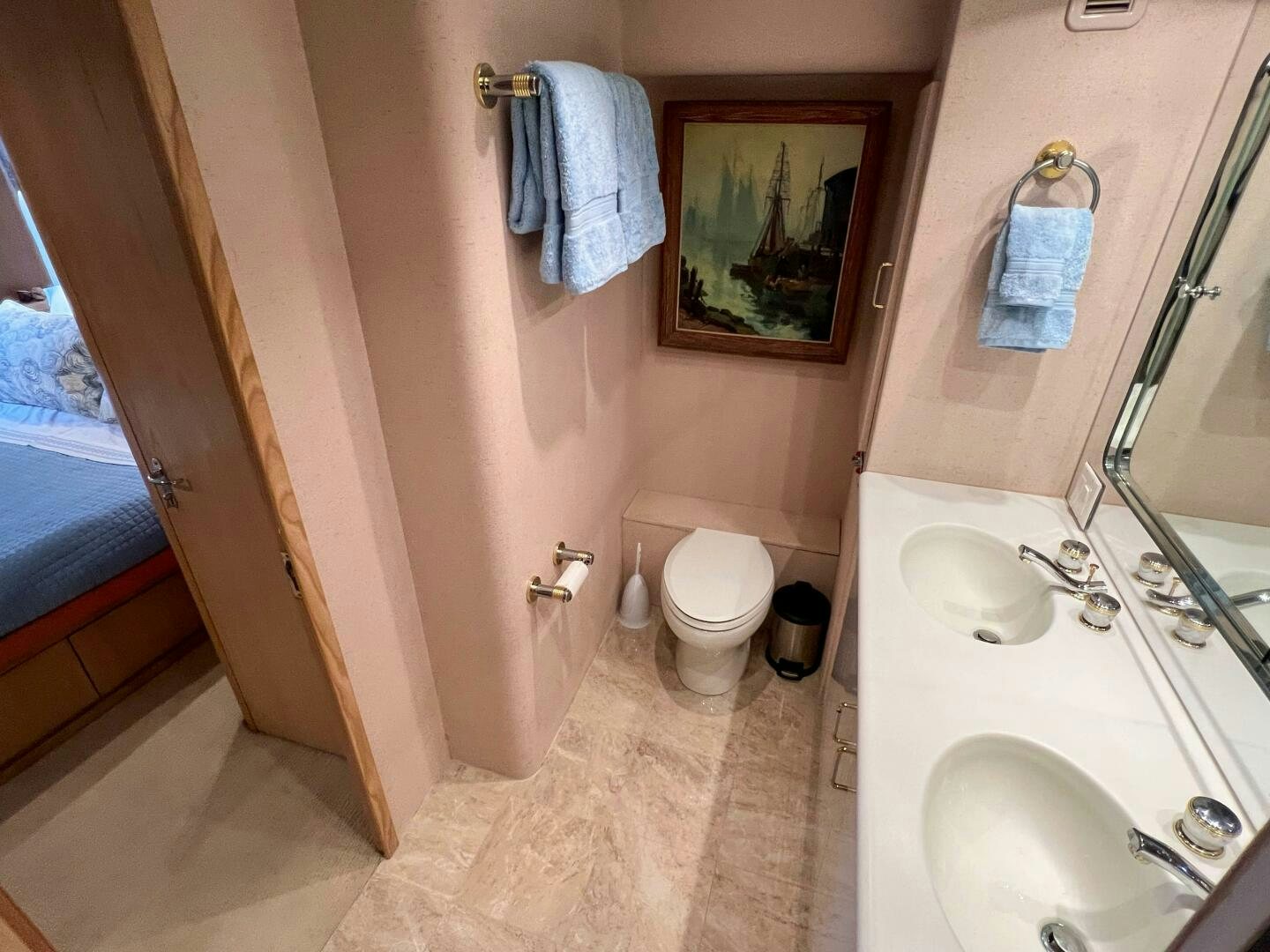 a bathroom with a toilet sink and a mirror aboard AT EASE Yacht for Sale