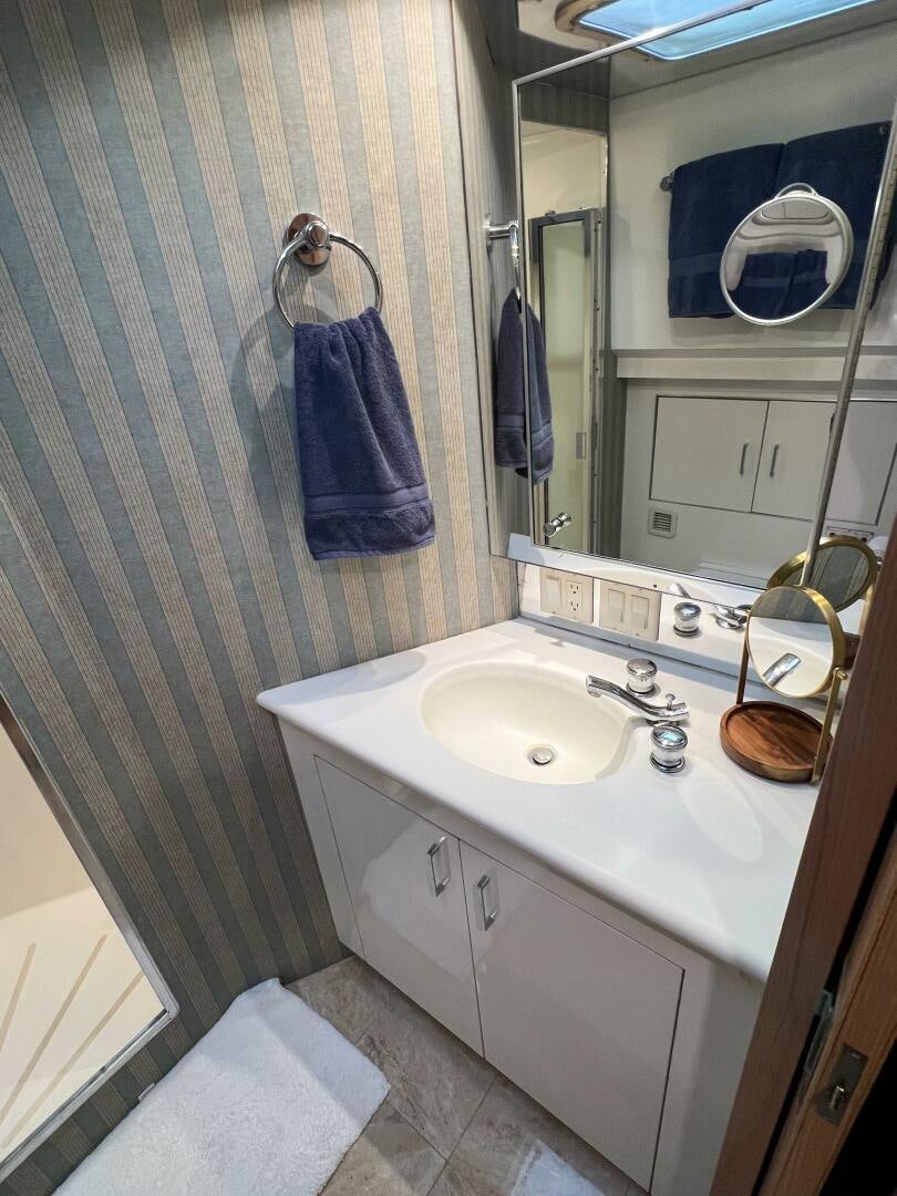a bathroom with a sink and a mirror aboard AT EASE Yacht for Sale