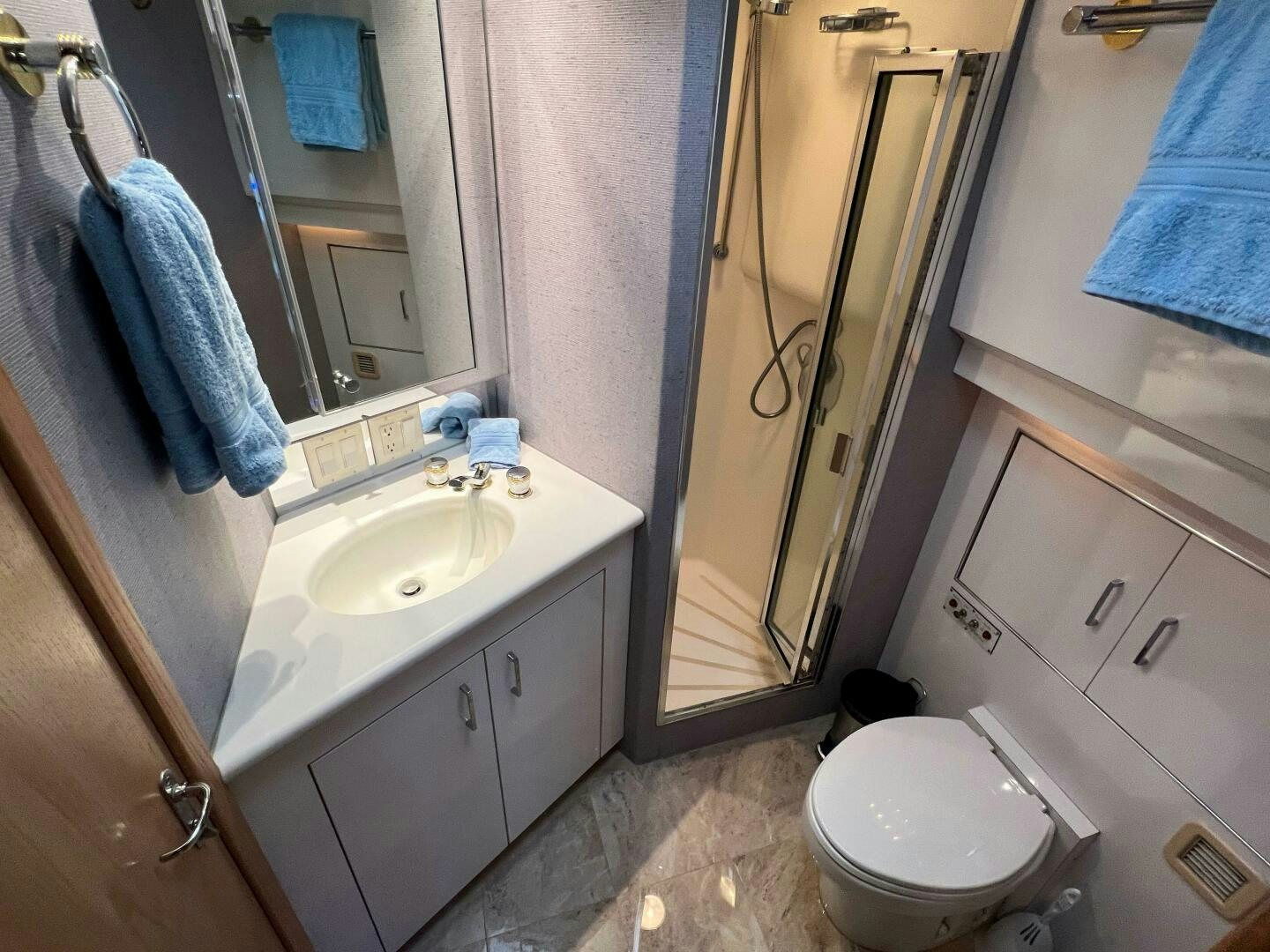 a bathroom with a toilet and sink aboard AT EASE Yacht for Sale