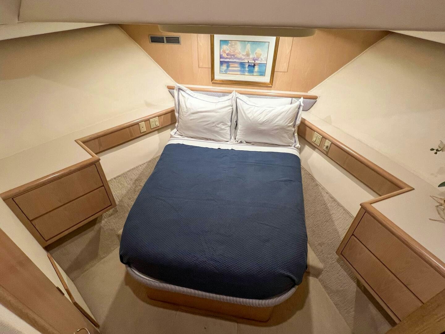 a bed with a blue sheet aboard AT EASE Yacht for Sale