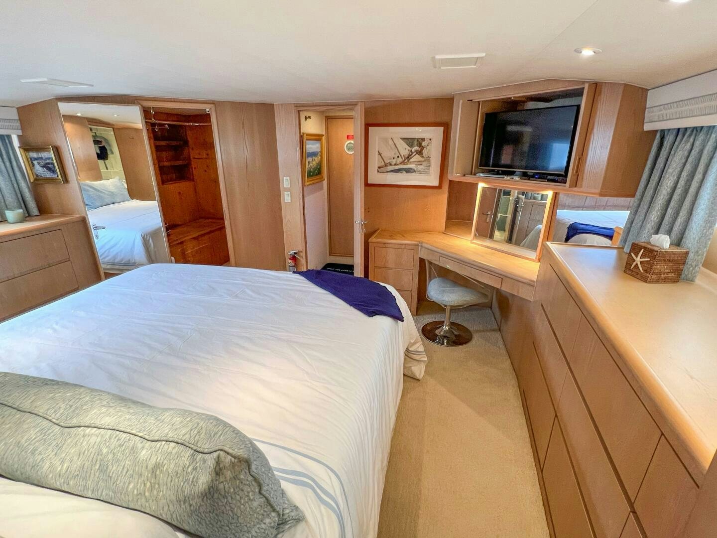 a bedroom with a bed and a desk aboard AT EASE Yacht for Sale
