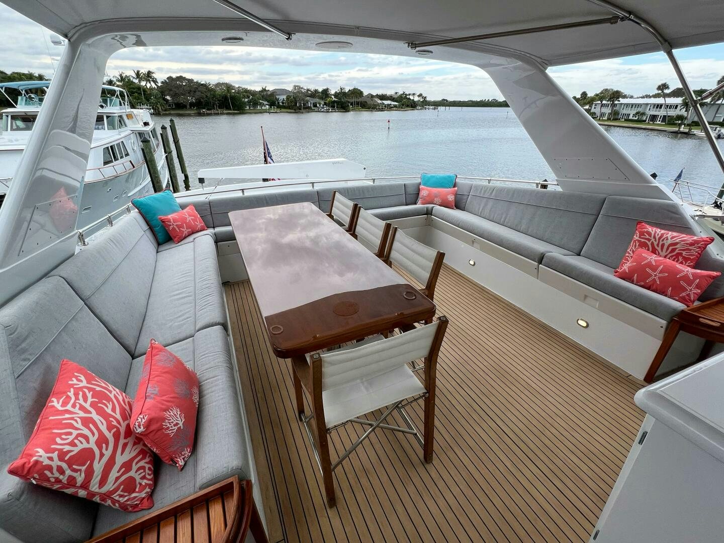 a deck with a table and chairs on it aboard AT EASE Yacht for Sale