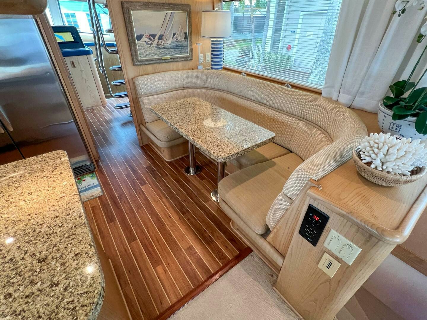 a living room with a table and chairs aboard AT EASE Yacht for Sale