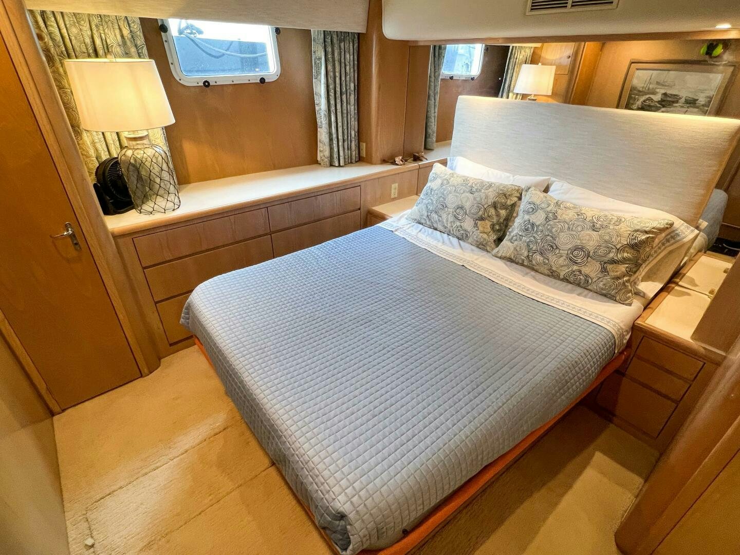a bed with a blue sheet aboard AT EASE Yacht for Sale