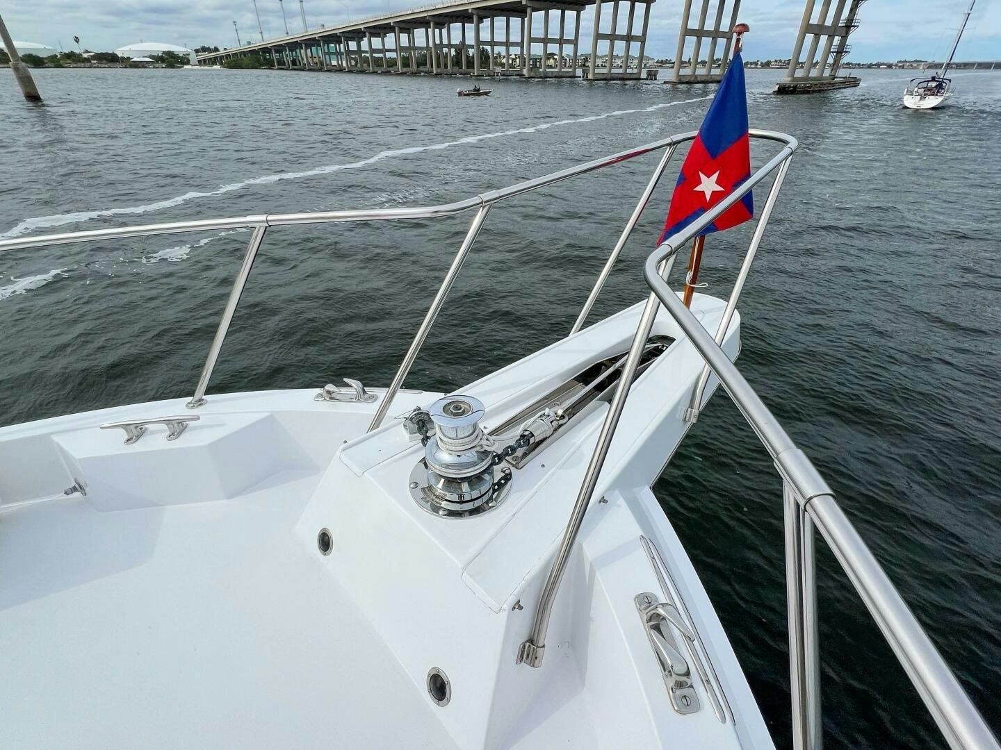 a boat with a flag on the front aboard AT EASE Yacht for Sale